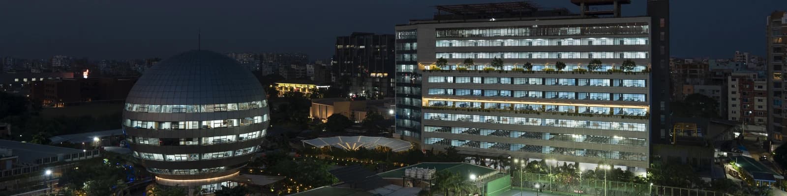 AIUB campus at dusk: the dome building and the main academic building